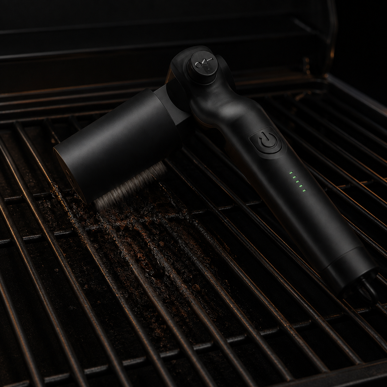 Electric grill brush head rotating against cooked-on residue